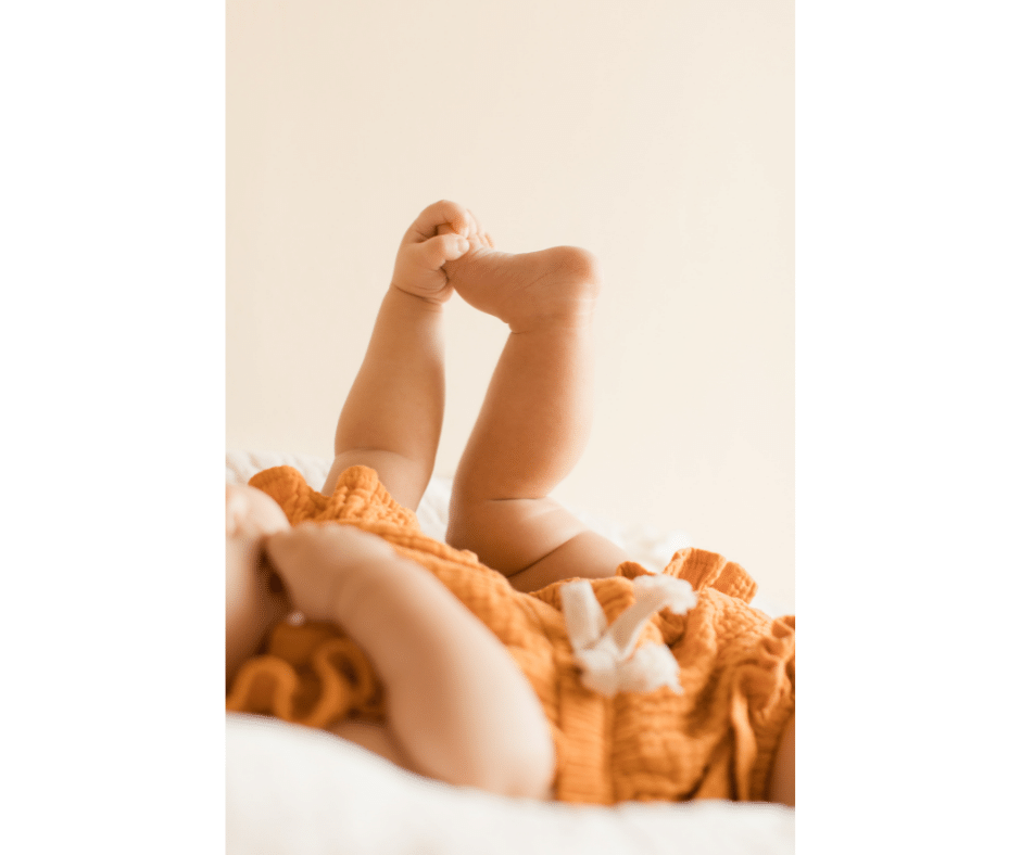 baby holding toes